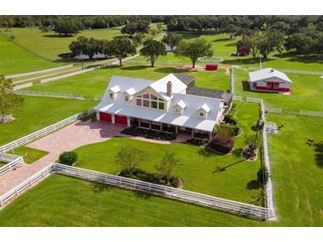Aerial view of a large home on a spacious lot with outbuildings at 39400 French Rd, Lady Lake, FL 32159