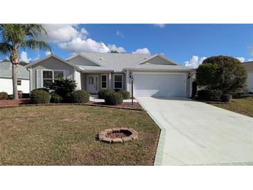 Charming single-story home with a landscaped front yard and attached two-car garage at 17755 Se 85Th Ellerbe Ave, The Villages, FL 32162