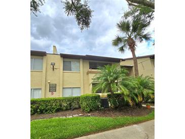 Exterior view of a condo building with landscaping at 6116 Curry Ford Rd # 229, Orlando, FL 32822