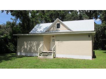 Small house with a metal roof and simple exterior design at 214 W Dade Ave, Bushnell, FL 33513