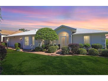 Single story home with landscaped yard and screened porch at 4809 Saint Andrews Arc, Leesburg, FL 34748