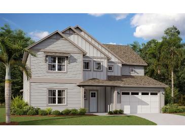 Two-story home with gray siding, white trim, and a two-car garage at 6208 Trailblaze Bnd, Saint Cloud, FL 34771