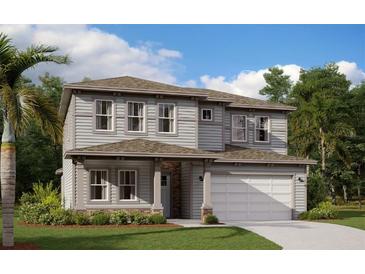 Two-story home with gray siding and a two-car garage at 6518 Circle Rock Way, Saint Cloud, FL 34771