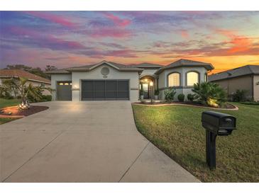 Beautiful home exterior with a two car garage and landscaped yard at 17257 Se 113Th Ave, Summerfield, FL 34491