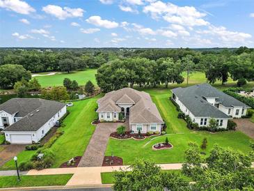 House with a large yard and golf course views at 5096 Greens Dr, Lady Lake, FL 32159