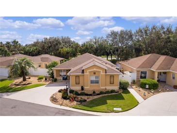 Aerial view of charming house and surrounding landscape at 1440 Fillmore Pl, The Villages, FL 32162