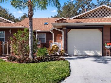 Front view of charming villa with a well-maintained lawn at 5550 Rosewall Cir, Leesburg, FL 34748