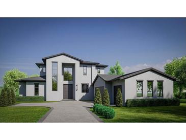 Two-story modern home with attached garage and landscaped lawn at 15618 Pendio Dr, Bella Collina, FL 34756