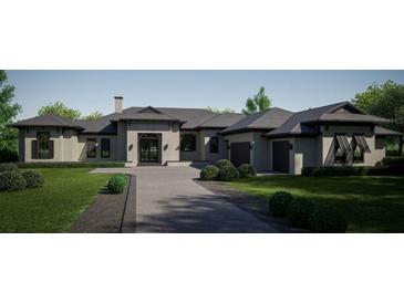 Luxury home exterior with a three-car garage and attractive landscaping at 15754 Pendio Dr, Bella Collina, FL 34756