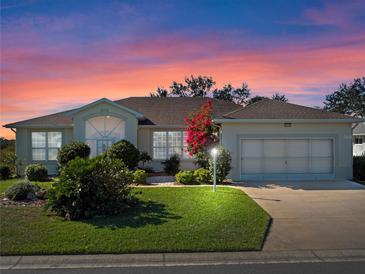 Beautiful home with a landscaped yard and two-car garage at 21732 King Henry Ave, Leesburg, FL 34748