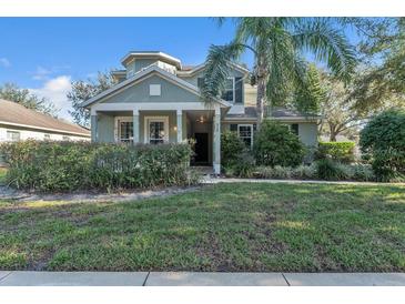 Two story house exterior, front yard, and landscaping at 929 Magnolia Blossom Ct, Apopka, FL 32712