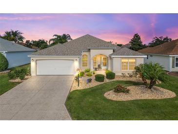 Attractive one-story home with a landscaped yard and a two-car garage at 397 Simpson St, The Villages, FL 32162