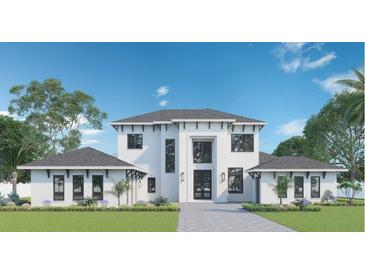 Two-story house with gray roof and white walls, landscaping, and a paved driveway at 16937 Crete Way, Bella Collina, FL 34756