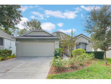 One-story house with a two-car garage and landscaped yard at 4130 Capland Ave, Clermont, FL 34711