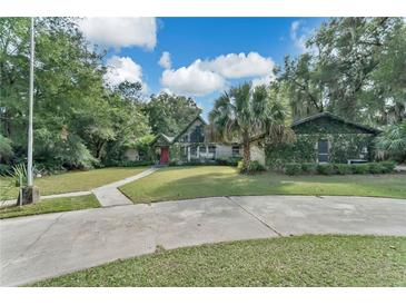 Ranch style home with mature landscaping and circular driveway at 4626 Ne 7Th St, Ocala, FL 34470