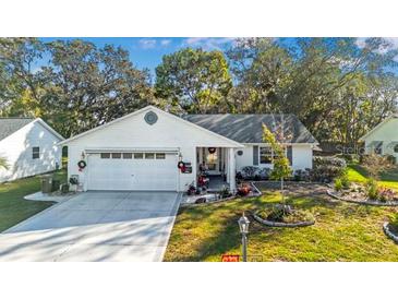 Charming single story home with a two car garage and well manicured landscaping at 1214 Loch Rannoch Ct, Leesburg, FL 34788