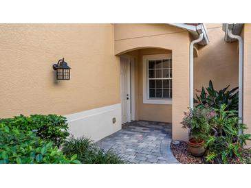 Inviting entryway with brick-paved walkway and landscaping at 41 Camino Real Blvd # 41, Howey In The Hills, FL 34737
