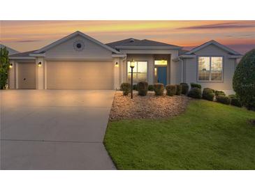 Attractive one-story home with a two-car garage and well-manicured landscaping at 2249 Quincy Ct, The Villages, FL 32162