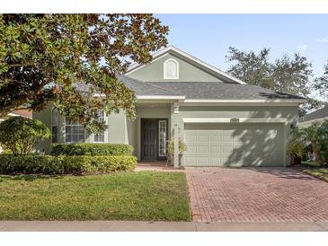 Single-story home with two-car garage and landscaping at 1063 Mesa Verde Ct, Clermont, FL 34711