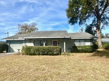 Ranch-style home with carport and mature landscaping at 1344 Cr 437, Lake Panasoffkee, FL 33538
