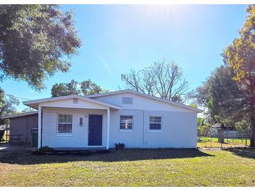 Charming single-story house with a freshly painted exterior and a well-maintained lawn at 605 Shiloh St, Fruitland Park, FL 34731