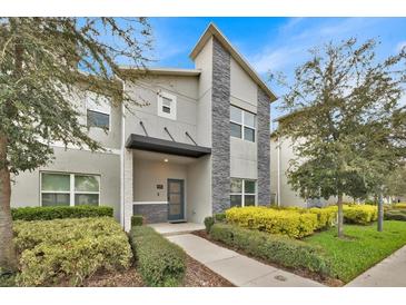 Modern two-story home with stone accents and landscaped front yard at 840 Pebble Beach Dr, Davenport, FL 33896