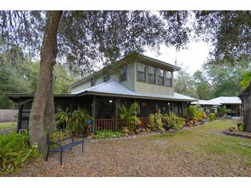 Inviting country home with large front porch and mature landscaping at 3140 Se 23Rd Pl, Sumterville, FL 33585