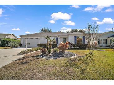 Single-story house with a landscaped lawn and driveway at 2514 Raintree Dr, The Villages, FL 32162