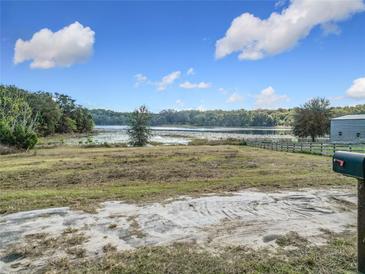 Scenic lakefront lot with a tranquil view, ready for your dream home at 4235 Dove Valley Ln, Lady Lake, FL 32159