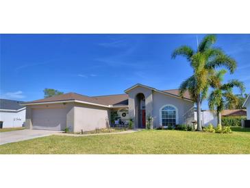 One-story house with a two-car garage and landscaped lawn at 7991 Apple Blossom Dr, Lakeland, FL 33810