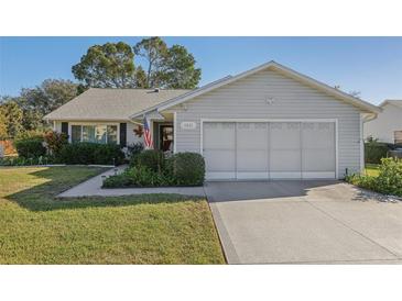 Charming single-story home with attached garage and landscaped front yard at 1511 New Abbey Ave, Leesburg, FL 34788