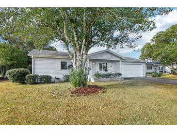 Ranch style home with carport and well-manicured lawn at 17754 Se 95Th Cir, Summerfield, FL 34491