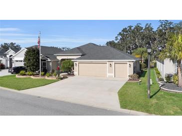 Attractive single-story home with three-car garage and landscaped front yard at 2717 Dunham Dr, The Villages, FL 32163