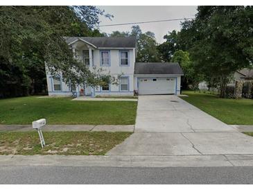 Two-story house with a driveway and yard at 1029 Kirk St, Orlando, FL 32808