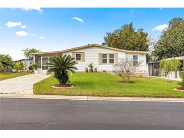 Single-story home with landscaped lawn and driveway at 811 Saint Andrews Blvd, The Villages, FL 32159