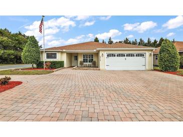 Well-maintained house with a paved driveway and landscaped yard at 5312 Galley Way, Oxford, FL 34484