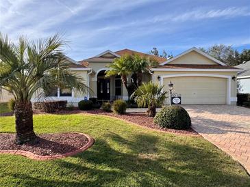 Attractive one-story home with landscaped yard and two-car garage at 752 Maybank Loop, The Villages, FL 32162