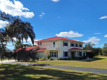 Two-story house with red roof and large yard at 20690 Sw 36Th St, Dunnellon, FL 34431