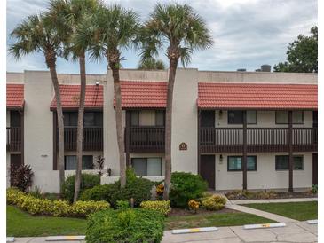Two-story building with Spanish-style architecture and lush landscaping at 8203 Village Dr # 8203, Lake Wales, FL 33898