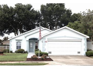 Charming single story home with two car garage and American flag at 231 Lake Suzanne Dr, Lake Wales, FL 33859