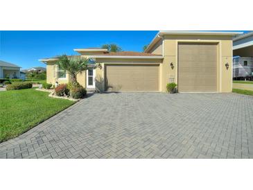 House exterior with a large driveway and attached garage at 360 Motorcoach S Dr, Polk City, FL 33868