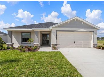 One-story home with attached garage and front yard at 2097 Summerlake Dr, Auburndale, FL 33823