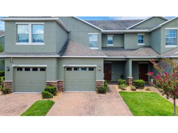 Two-story townhome with two-car garage and landscaped front yard at 6477 Sedgeford Dr, Lakeland, FL 33811