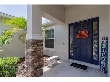 Inviting entryway with a blue door and stone accents at 6769 Hampshire Blvd, Lakeland, FL 33813