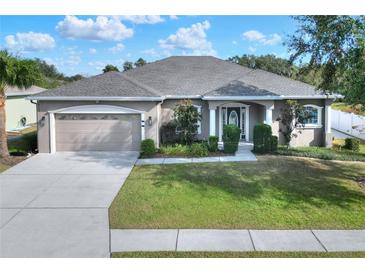 One-story home with a large front yard, attached garage, and attractive landscaping at 4756 Acorn Dr, Mulberry, FL 33860