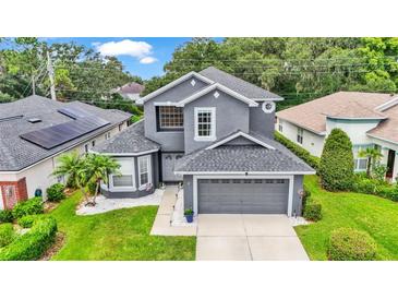 Two-story house with gray exterior and a two-car garage at 6857 Eagle Ridge Loop, Lakeland, FL 33813