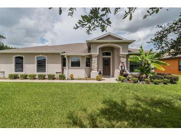 Single-story home with landscaped yard at 1619 Prairie Blossom Dr, Lakeland, FL 33810