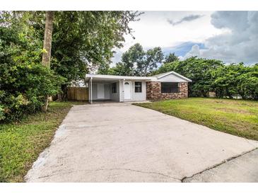 Brick ranch house with carport and large lawn at 415 Lucille St, Bartow, FL 33830