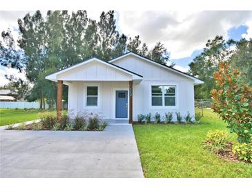 Charming craftsman style home with a blue door and landscaped yard at 112 5Th Se St, Fort Meade, FL 33841