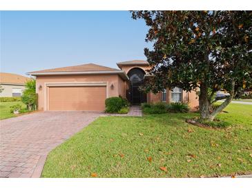 Single-story home with a two-car garage and well-manicured lawn at 5359 Nicklaus Dr, Winter Haven, FL 33884